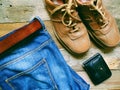 men& x27;s leather shoes, blue jeans with a belt and a black purse Royalty Free Stock Photo
