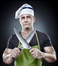 Menacing man cook holding two sharp knives Royalty Free Stock Photo