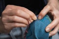 Mending clothes. Visible mending repairing sock