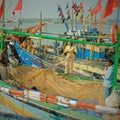 Mending nets at the quayside