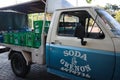 Truck delivers bottled water. Open trailer truck unloads drinking water in large bottles