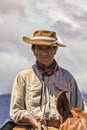 Mendoza, Argentina - March 25, 2015 - goucho walks his horse past camera