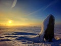 Menhir in winter landscape.