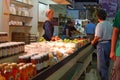 A Mennonite woman minds an organic food vendor stall