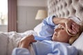 Menopausal Mature Woman Suffering With Insomnia In Bed At Home 