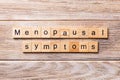 Menopausal symptoms word written on wood block. menopausal symptoms text on wooden table for your desing, concept Royalty Free Stock Photo