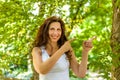 Menopausal woman points with index fingers on left Royalty Free Stock Photo