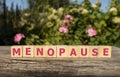 Menopause word written on wood block. menopause text on table, concept