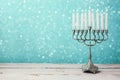 Menorah with candles for Hanukkah celebration over bokeh background Royalty Free Stock Photo