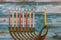 Menorah with colorful candles for Hanukkah on light, close up