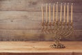 Menorah on wooden table, Hanukkah celebration