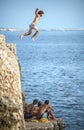 Menorca, Spain - September 8: Young man jumping from cliff into the sea, in September 8, 2014 in Menorca, Spain Royalty Free Stock Photo