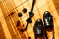 Mens black shoes Tassel loafers with bow tie and sunglasses on wooden background.