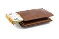 Mens brown leather wallet with a stack of Euro notes sticking out of the center, isolated on a white background, visible 50 Euro.