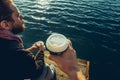 Mens drinking coffee sitting on the pier and enjoying the sea view, Point Of View Shot Royalty Free Stock Photo