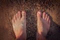 Mens feet on the beach Royalty Free Stock Photo