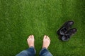 Mens feet resting on green grass