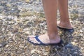 Mens feet in sandals on the beach. Royalty Free Stock Photo