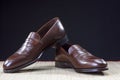 Mens Footwear Concepts. Pair of Stylish Brown Penny Loafer Shoes Placed on Straw Surface