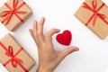 Mens hand shape heart near red heart and present box top view isolated white background. Valentines day concept. flat lay