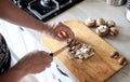 Mens hands cut Fresh mushrooms in kitchen