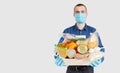 Mens hands hold Quarantine donation box. Food, clothing and personal protective equipment. Royalty Free Stock Photo