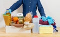 Mens hands hold Quarantine donation box. Food, clothing and personal protective equipment. Royalty Free Stock Photo