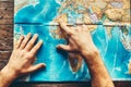 Mens Hands On A Paper Map Of The World Indicate The Final Destination, Top View