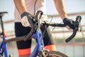 Mens hands in sports gloves holding bicycle handlebar Royalty Free Stock Photo