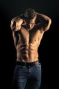 Mens heals body care. Man sportsman show muscular torso in jeans on black background