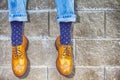 Mens Legs Wearing Brown Oxfords Semi Brogues Shoes. Posing Outdoors Against Stony Grunge Background Royalty Free Stock Photo