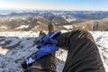 Mens legs in winter shoes against panorama over the Carpathian m