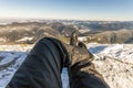 Mens legs in winter shoes against panorama over the Carpathian m