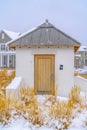 Mens Restroom against snowy grasses and homes