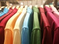 Mens shirts in different colors on hangers in a retail clothes s Royalty Free Stock Photo