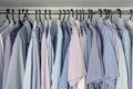 Mens shirts on hangers in the closet. Blue and pink shades. Storage of clothes Royalty Free Stock Photo