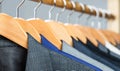 Mens shirts, suit hanging on rack. Hangers with jackets on them in boutique. Suits for men hanging on the rack. Mens Royalty Free Stock Photo