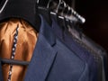 Mens suits on hangers in different colors Royalty Free Stock Photo