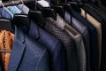 Mens suits on hangers in different colors Royalty Free Stock Photo