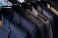 Mens suits on hangers in different colors