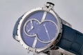 Mens watch with leather blue strap with blue dial, silver numbers and silver clockwise and stopwatch on white background.