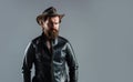 Mens western wardrobe. fashionable man dressed in leather jacket. west fashion model. handsome man in cowboy hat Royalty Free Stock Photo