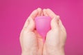 Menstrual cup in female hands, women`s health care, gynecologist concept, hygiene products