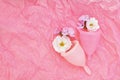Menstrual cup on light pink and white rose flowers background, ecological reusable intimate hygiene image