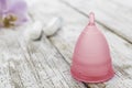 Menstrual cup on an old wooden table