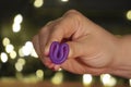 Menstrual Cup on red or black background in the girl hand, low key. woman hands folding a menstrual cup. lights in the background. Royalty Free Stock Photo