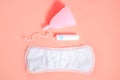 Menstrual cup, sanitary pad and swab on a pink background. Concept of menstruation, feminine hygiene products. Flat lay. copy