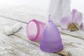 Menstrual cup with tampon on an old wooden table