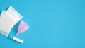 Menstrual hygiene products top view. Flat lay menstrual cup, sanitary pads, tampon on blue background with copy space. Women Royalty Free Stock Photo