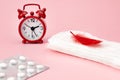 Menstrual pads, blood period calendar, clocks and pills. White pharmaceutical tablets. Menstruation period pain protection. Contra